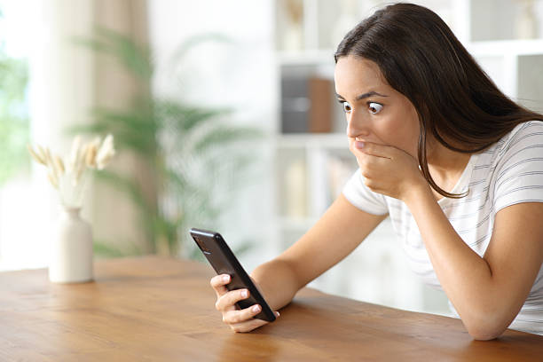 istock Shocked woman checking surprising content on cell phone 2242935381