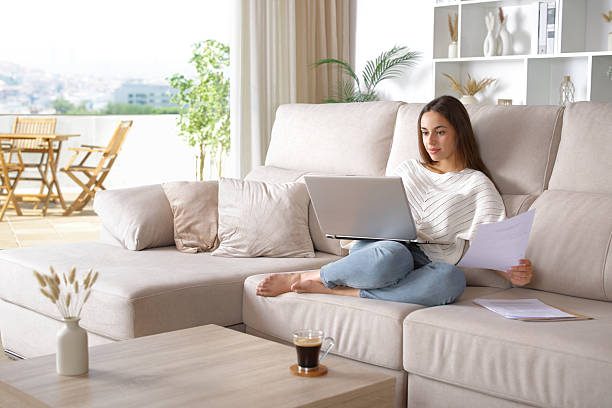 istock Woman working online using laptop checking documents at home 2242935424