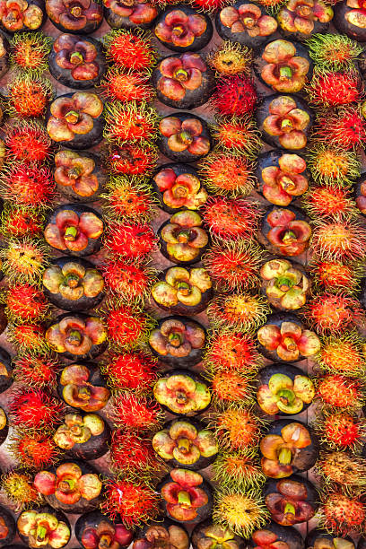 Mangosteen and rambutan arranged on the board