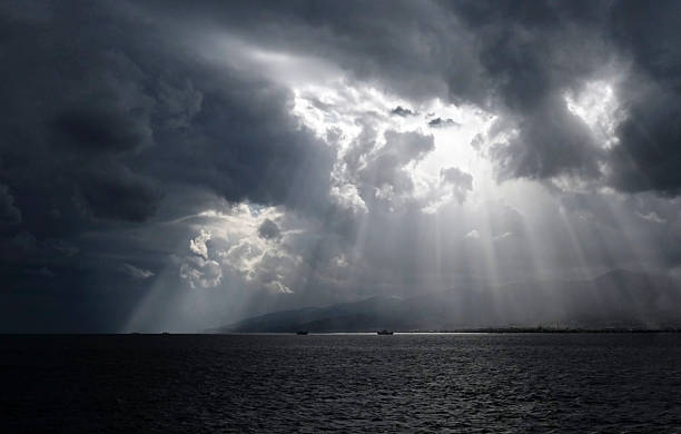 istock Sunlight breaking through the clouds between Calabria and Sicily in Italy 2242938075