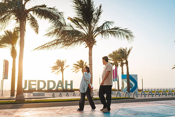 istock Happy Young Diverse Couple Strolling Near Jeddah Sign 2242938580
