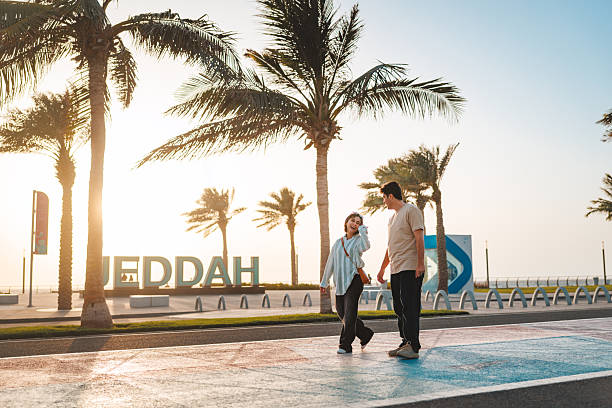 istock Joyful Diverse Individuals Strolling Near Iconic Jeddah Sign 2242938598