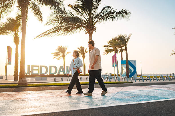 istock Delighted Young Adults Walking Beside Iconic Landmark at Sunset 2242938601