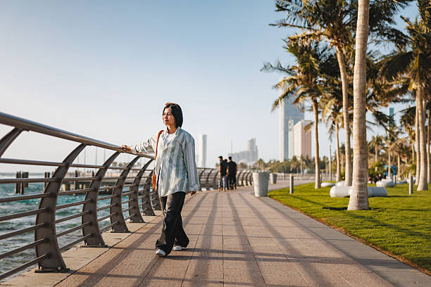 istock Relaxed Female Tourist Enjoying Jeddah Corniche Waterfront Stroll 2242939049