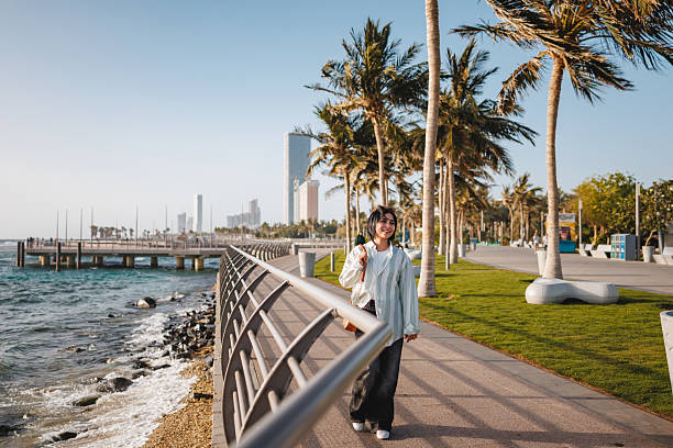 istock Joyful Woman Enjoying Scenic Walk by Waterfront 2242939058