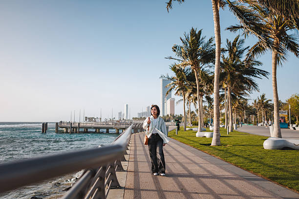 istock Content Female Enjoying Scenic Walk by Seaside Promenade 2242939070