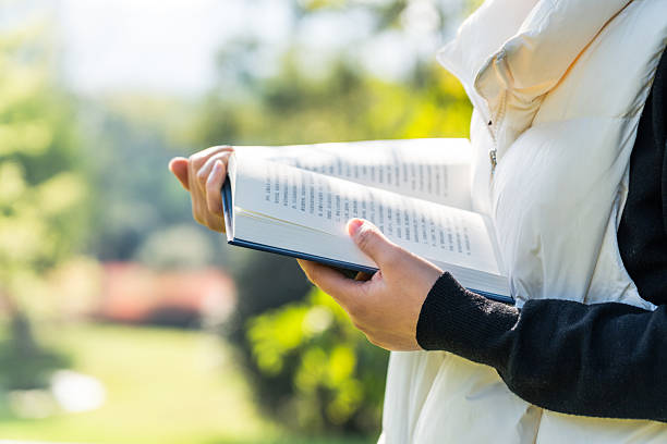 istock A person reading a book outdoors in a natural environment 2242939134