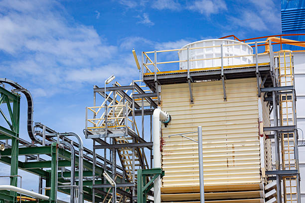 istock Cooling tower and modern engineering structure of an industrial factory featuring chemical pipelines 2242939372