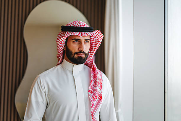 istock Young Middle Eastern Male in Traditional Attire Looking Confidently Out Window 2242939728