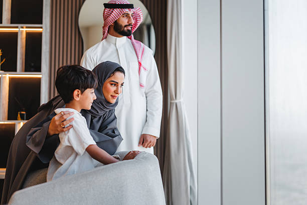 istock Middle Eastern Family Enjoying View From Luxury Apartment Window Together 2242939801