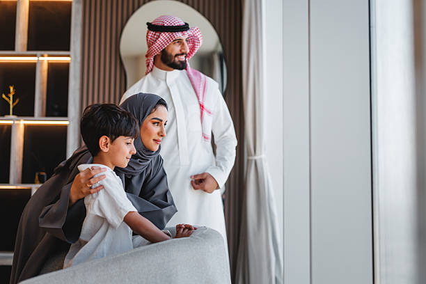 istock Middle Eastern Family Admiring Beautiful View From Luxury Apartment Window 2242939806