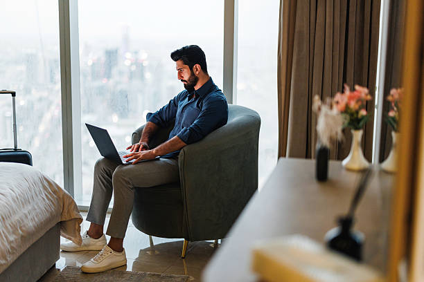 istock Middle Eastern Businessman Analyzing Data on Laptop in Riyadh Luxury Hotel Room 2242939837