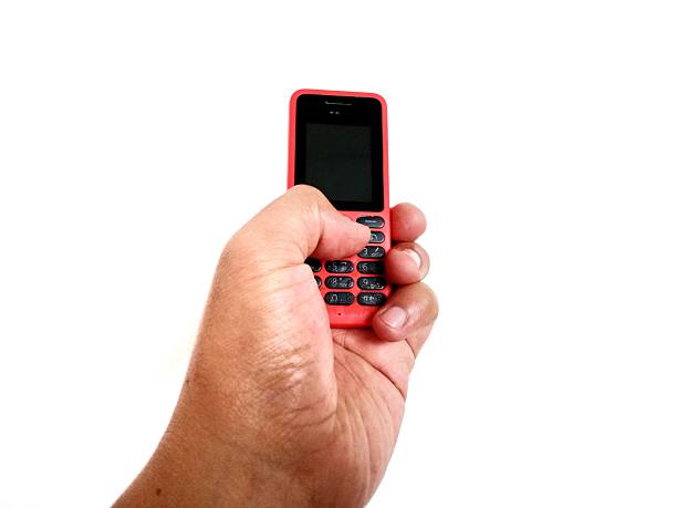 istock Jakarta, Indonesia, hand pose holding an old cellphone 2242939842