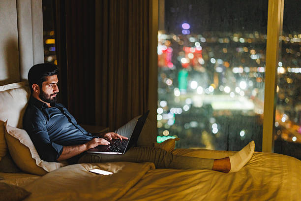 istock Confident Arabic Businessman Using Laptop with Riyadh Cityscape in Luxury Hotel 2242939917