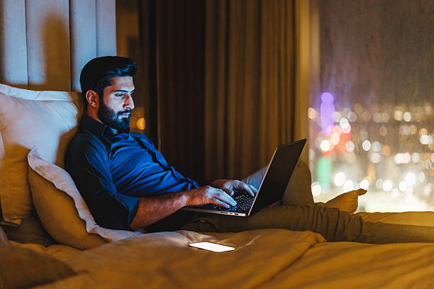 istock Focused Middle Eastern Businessman Working Late on Laptop in Hotel Room 2242939948