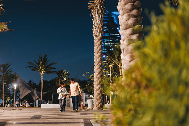 istock Engaged Friends Enjoying Nighttime Walk by Palm Trees 2242944230