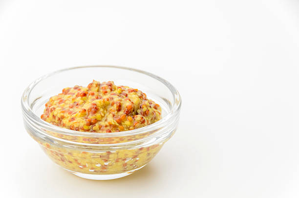 istock whole grain mustard in small glass bowl on white background 2242944851
