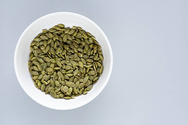 istock Organic hulled pumpkin seeds in minimalist composition 2242945759