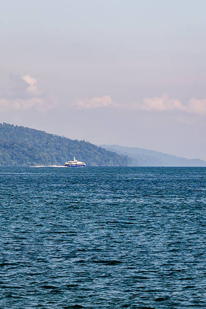 istock scenic ocean view with distant forested island and calm waters at sunrise 2242946029