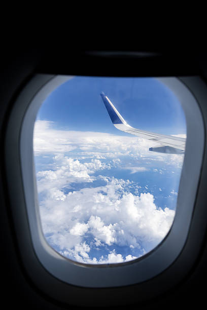 istock plane wing above blue sky horizon seen from window 2242947090