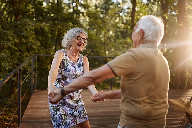 istock Cheerful senior couple dancing in springtime on a patio. 2242947311