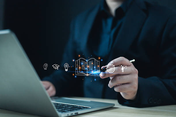istock Businessman using laptop with digital education and knowledge learning icons. Concept of e-learning, innovation, smart technology, and online training for modern business development. 2242947672