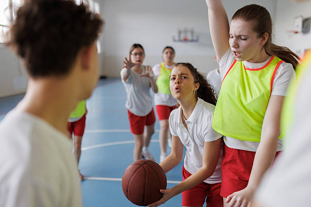 istock Teenagers playing basketball during physical education class 2242947755