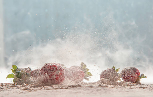 strawberries in motion, jumping in powdered sugar