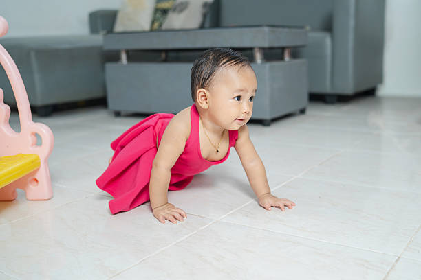 Baby girl crawling forward with happy expression, concept of growth, learning, and movement