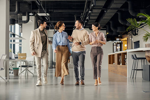 istock Business colleagues walking and talking in modern office 2242951913