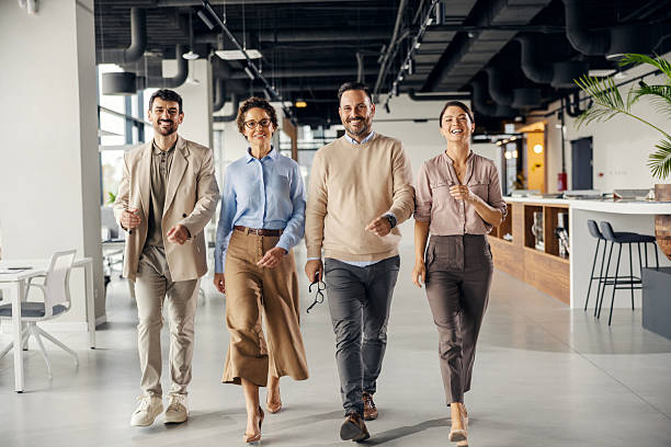 istock Business people team walking and smiling in office 2242951920