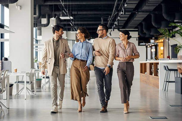 Business colleagues walking and talking in modern office