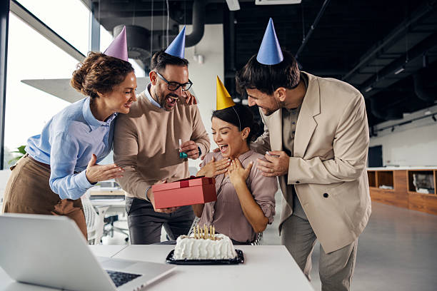 istock Colleagues celebrating coworker's birthday with gift and cake 2242951976