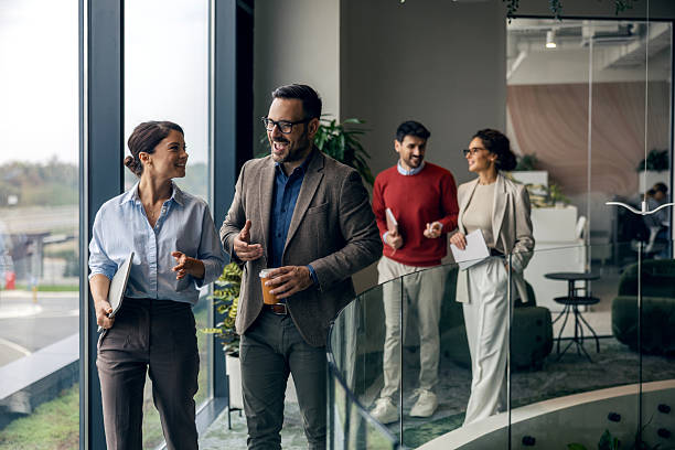 istock Business colleagues walking and talking in modern office 2242952101
