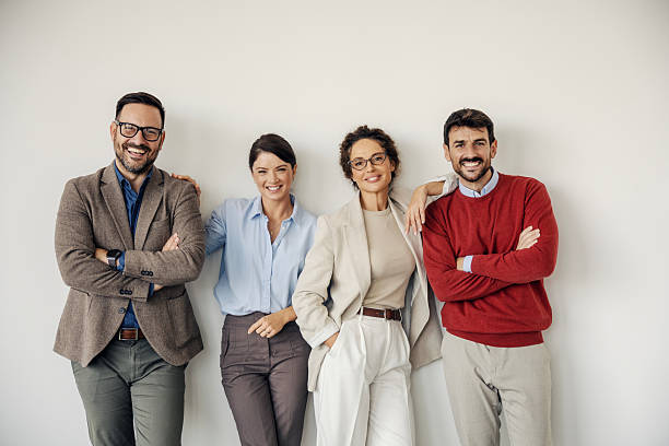 istock Business team colleagues smiling and standing against wall 2242952162