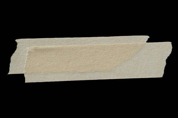 Adhesive torn paper masking tape isolated on black background