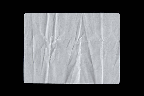 istock White adhesive glued paper sticker label on isolated black 2242954467