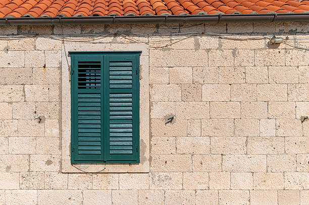 istock Green shuttered window on a stone wall in Dubrovnik, Croatia during daytime 2242954487