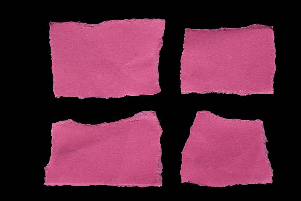 Ripped pink paper torn edges isolated on black background, paper tear