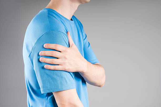 istock Dislocation of the shoulder, joint inflammation, arthritis and degenerative changes, man with pain in his arm on gray background 2242955500