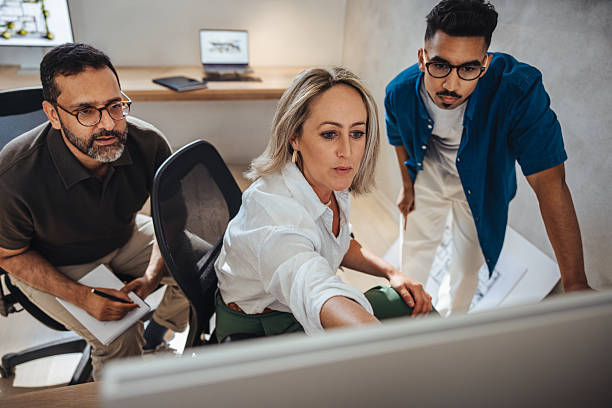 istock Professional collaboration of architects discussing a project in a modern office 2242955852