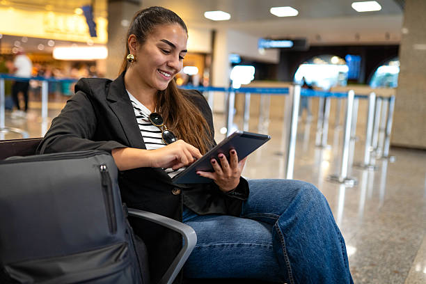 istock A woman at the airport using smartphone 2242958736