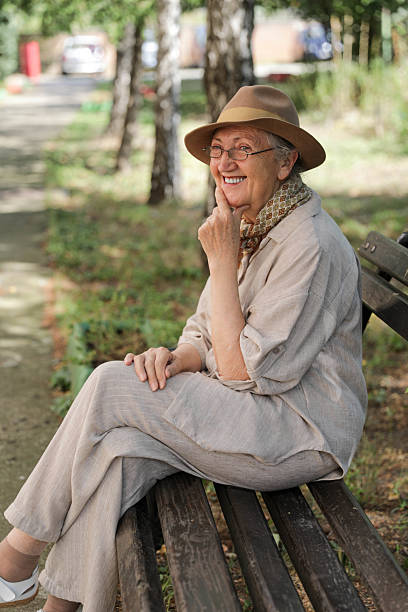 istock Cheerful Elderly Lady with Glasses and Hat 2242961739