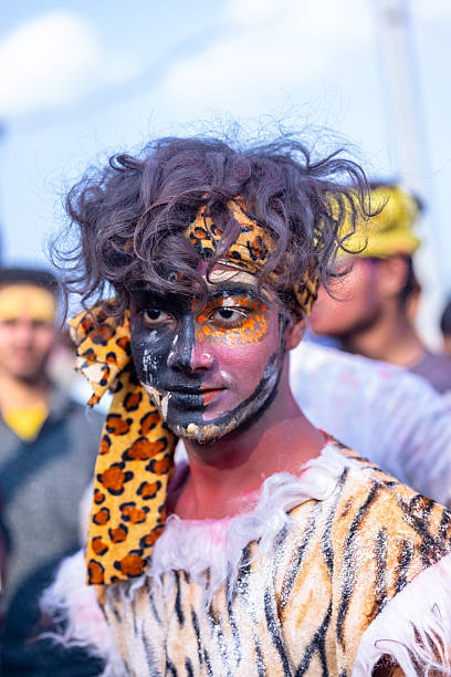 Varanasi, Uttar Pradesh, India - March 2024: Masan Holi, Portrait of unidentified devotee with painted face with organic colours during the celebration of masan holi at manikarnika ghat.