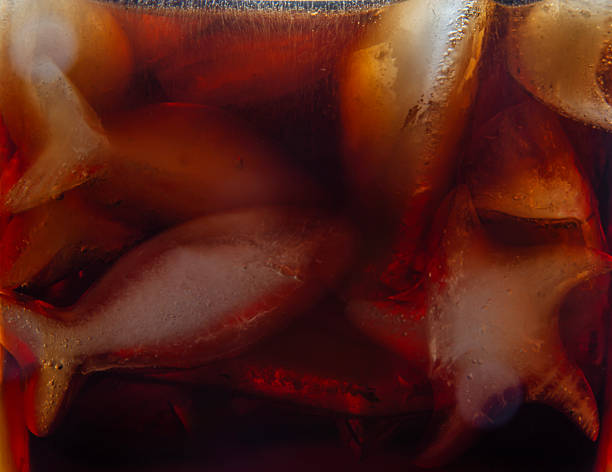 A detailed and vivid view of bottles showcasing striking red caps and their sparkling contents,