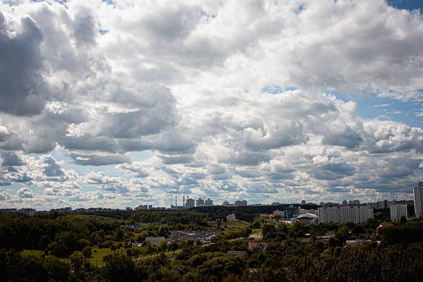 Beautiful view of blue sky with clouds. Partly cloudy. Background cloud summer. Natural sky cinematic beautiful texture background. Clouds over the silhouette of the city.