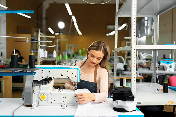 istock Beautiful female seamstress working with fabric at her workplace 2242979987