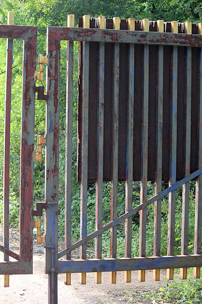 Rustic Metal Gate with Vertical Bars in Garden Entrance