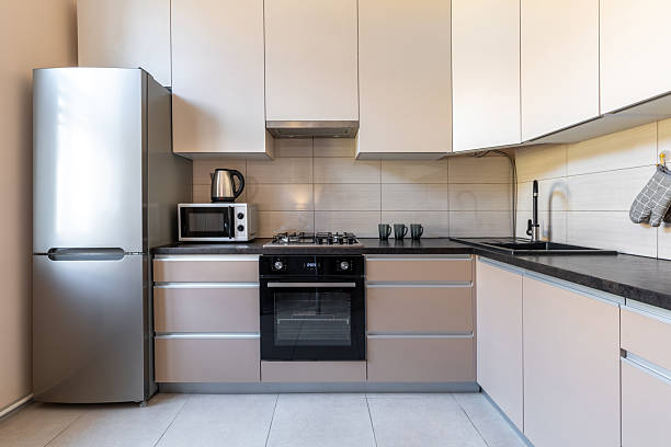 istock Modern Minimalist Kitchen with Beige Cabinets and Appliances 2242984316