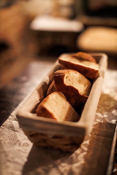 Freshly baked bread served in a rustic basket during a cozy dinner setting in the evening